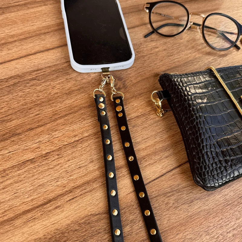 Colgador móvil negro tachas oro